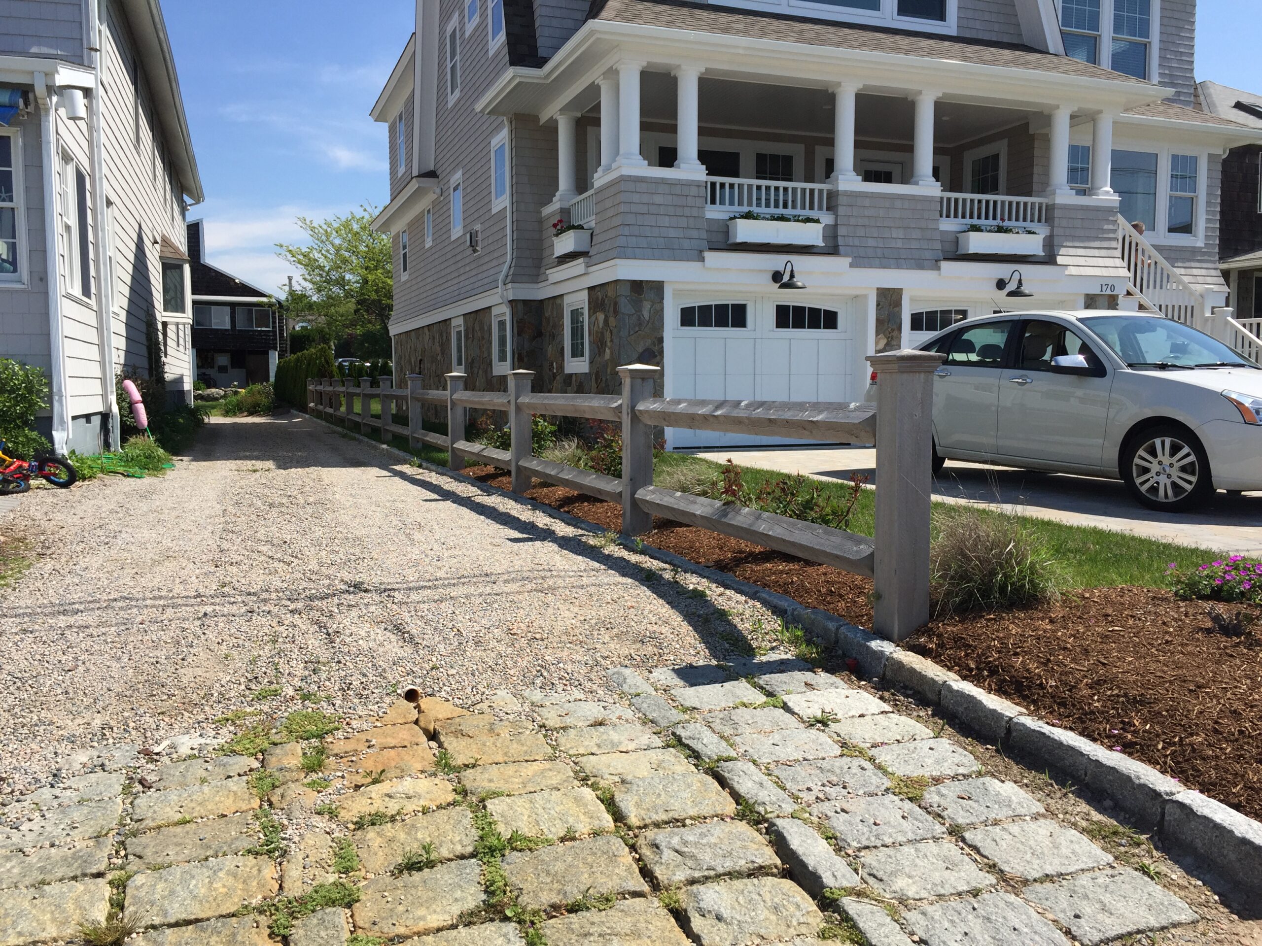 Estate-style square rail fence along a driveway installed by Arrow Fence in Connecticut